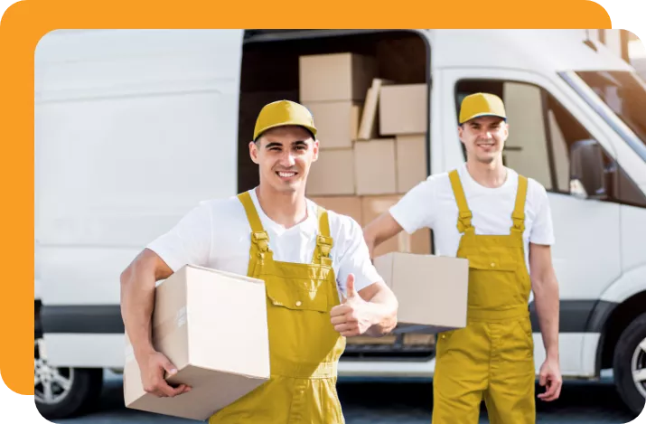 Happy movers holding cardboard boxes